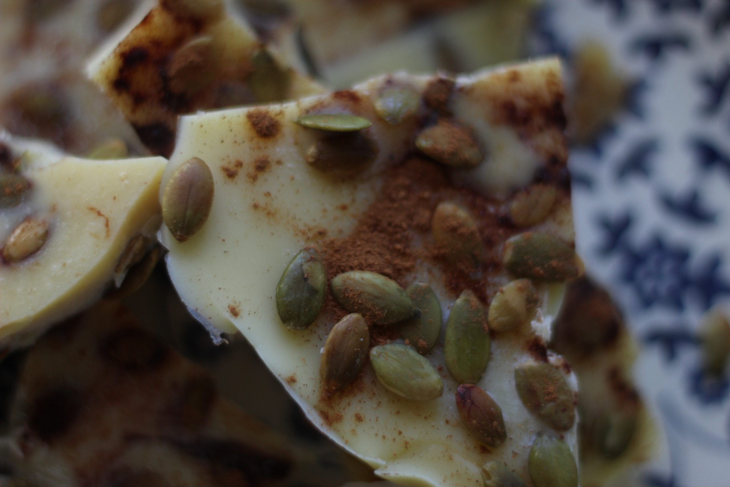 close-up photo of Pumpkin Seed Cacao Bark broken into large pieces on a plate