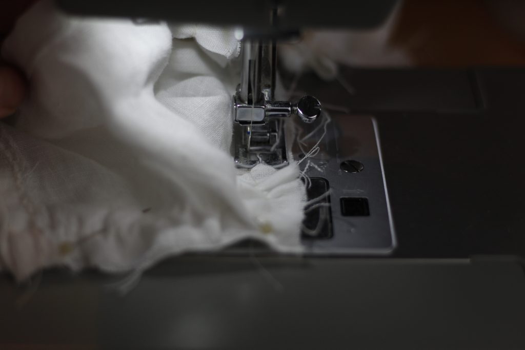 picture of sewing machine sewing the seam around a corner of the project