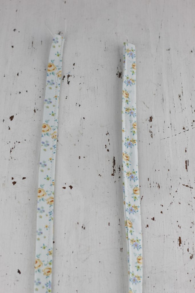 image of sewn blue floral straps on a white table