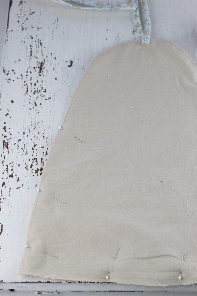 image of pinned tan fabric beehive lying on a white table