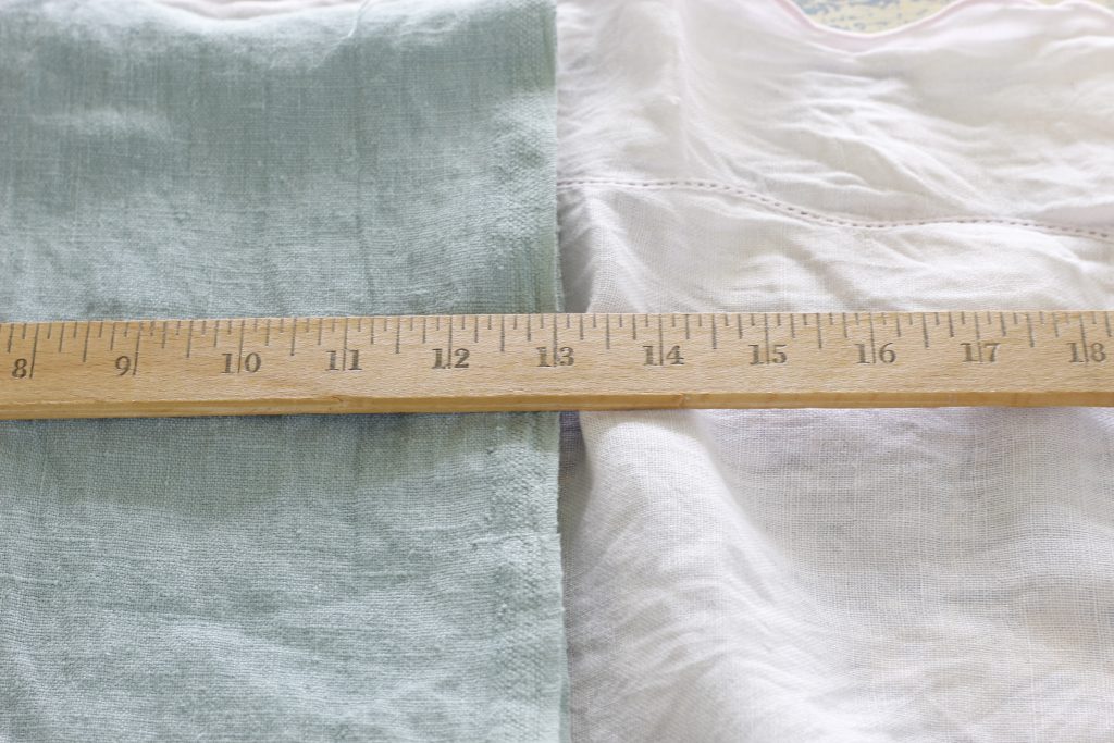 picture of green fabric being measured on a table covered with a pink cloth