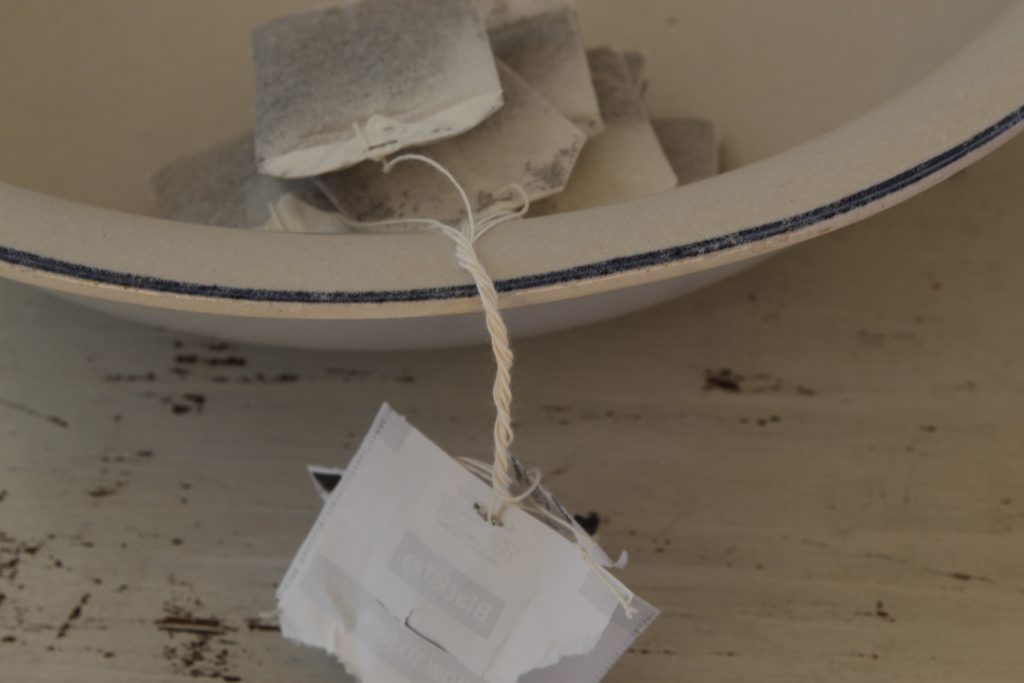image of tea bags in a white and blue bowl on a white table