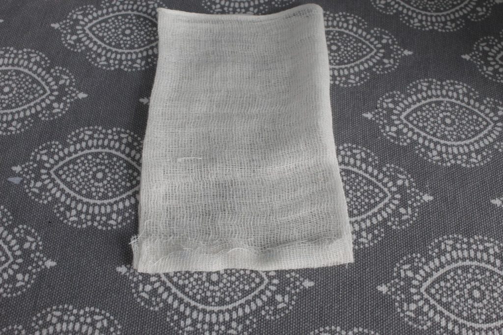 This is an image of the pocket showing the bottom edge folded up and pressed lying on a grey covered ironing board.