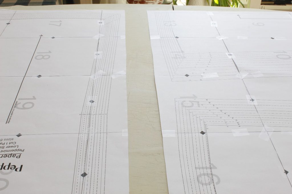 This image shows the result of cutting the two halves of the sewing pattern apart, showing that it's easier to work with two smaller sheets rather than one large one.