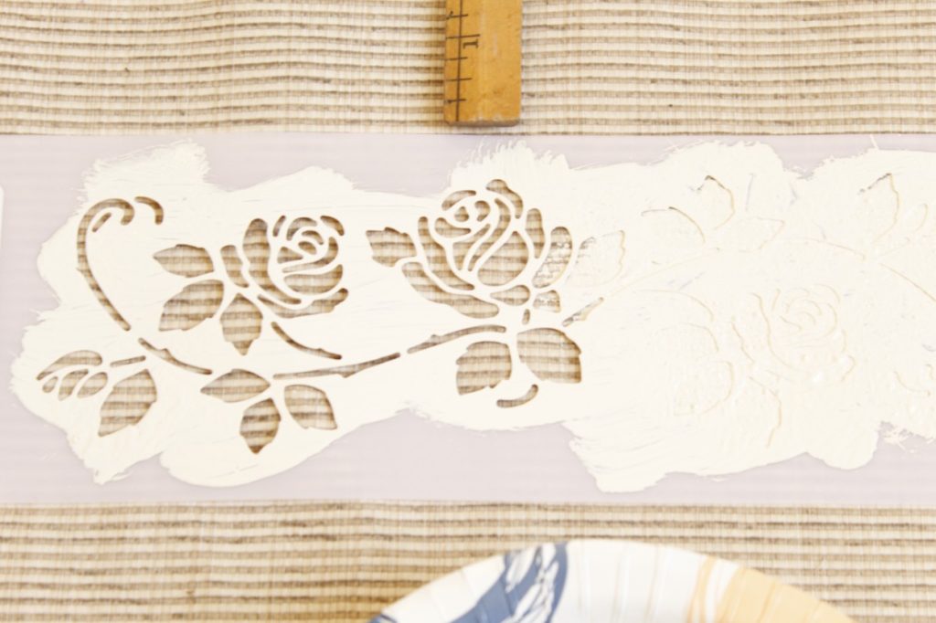 This image shows the stencil half-filled in with white paint.