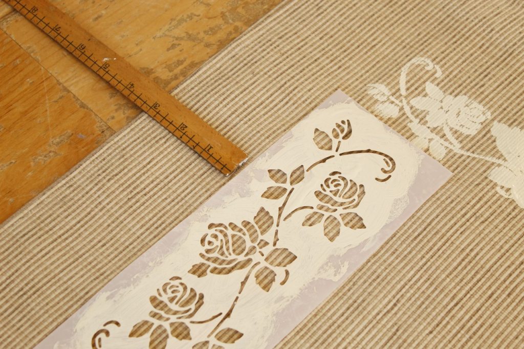 This image shows that the stencil was moved to a new spot and where the stencil meets at a corner of the rug.