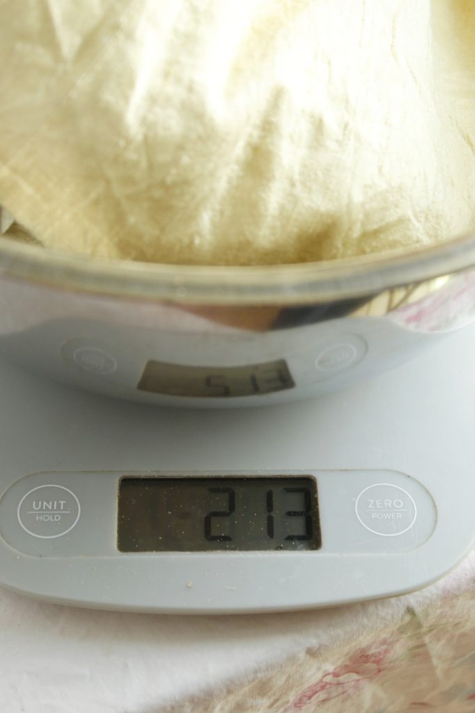 This image shows the mordanted silk fabric being weighed on the digital scale, the weight is a little heavier after being mordanted.