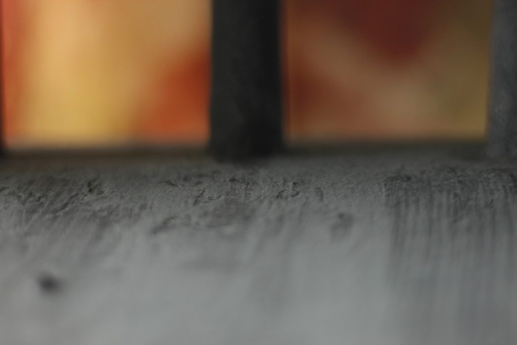 This image is very close, showing the texture and depth of the color of paint. It is a very dark, inky blue.